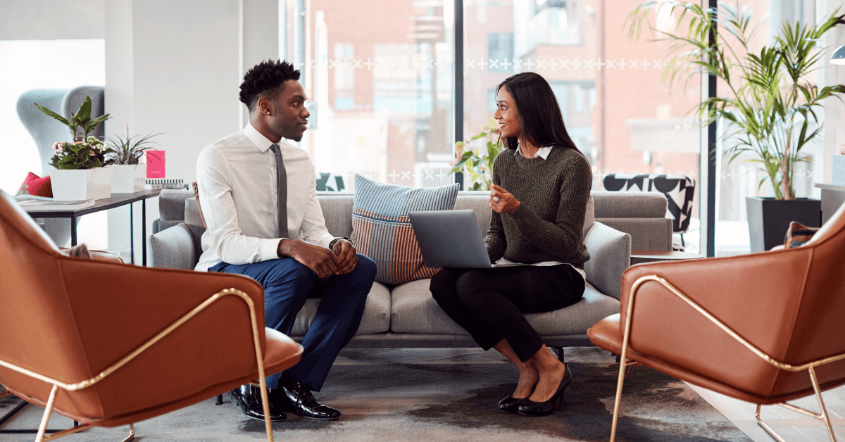 Candidata conversando com uma recrutadora em uma sala de espera de escritório